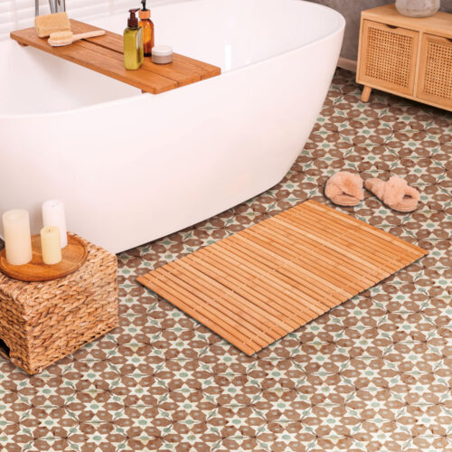 Stylish bathroom interior with bamboo bath mat and white tub